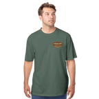 Man wearing a green t-shirt with a logo on a white background