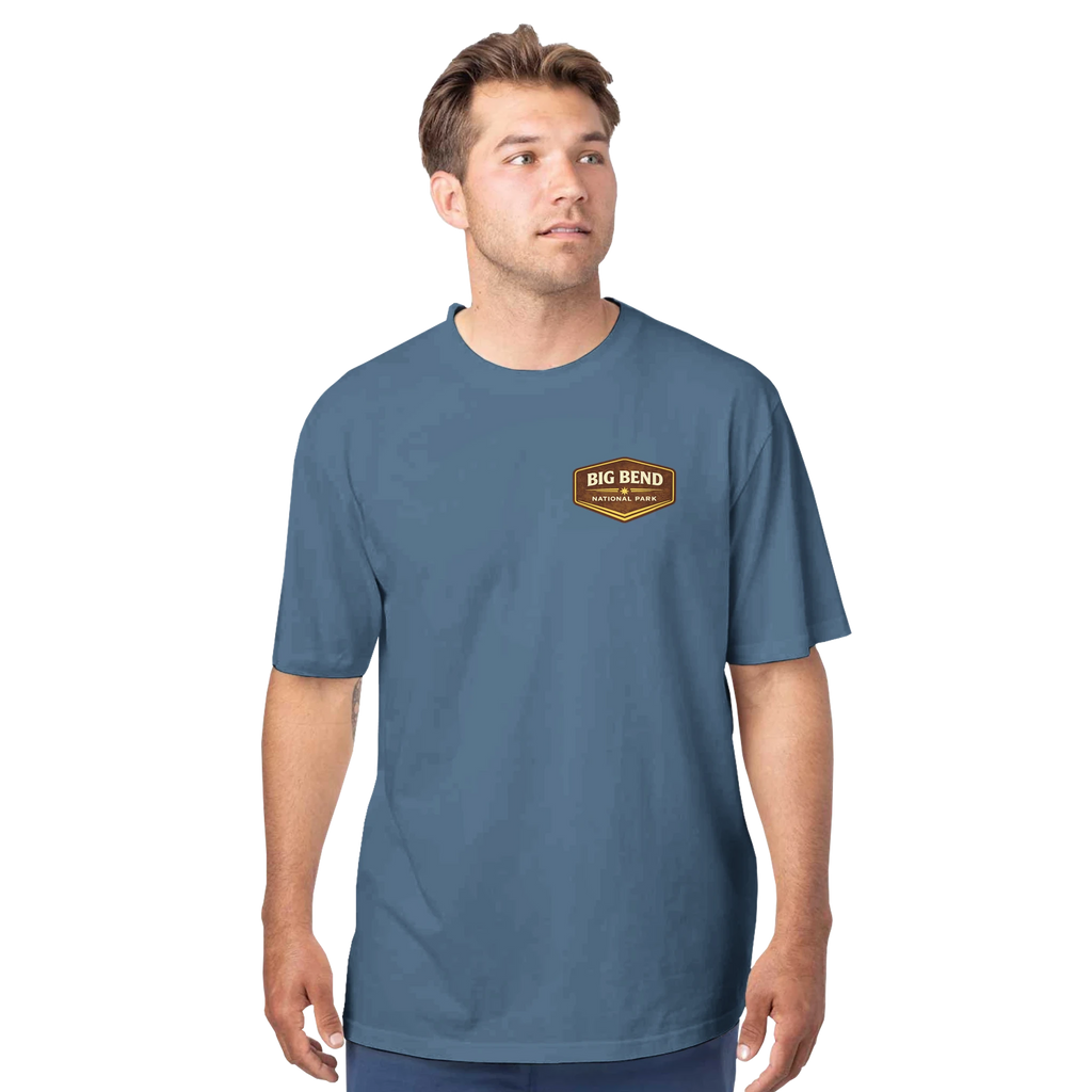 Man wearing a blue t-shirt with a logo on a white background