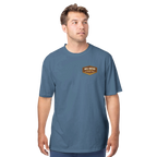 Man wearing a blue t-shirt with a logo on a white background