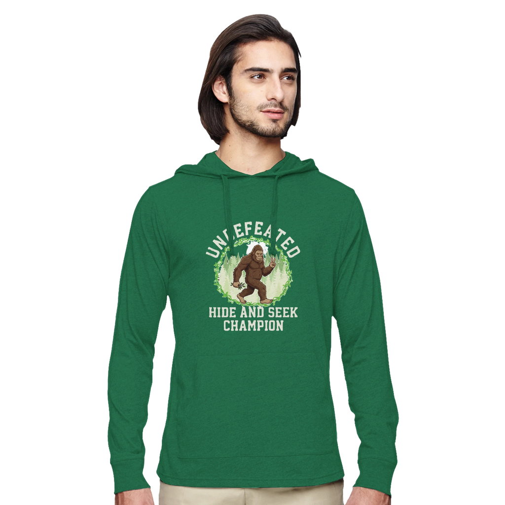 Man wearing a green bigfoot hoodie with a graphic design on a white background