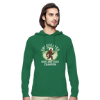 Man wearing a green bigfoot hoodie with a graphic design on a white background