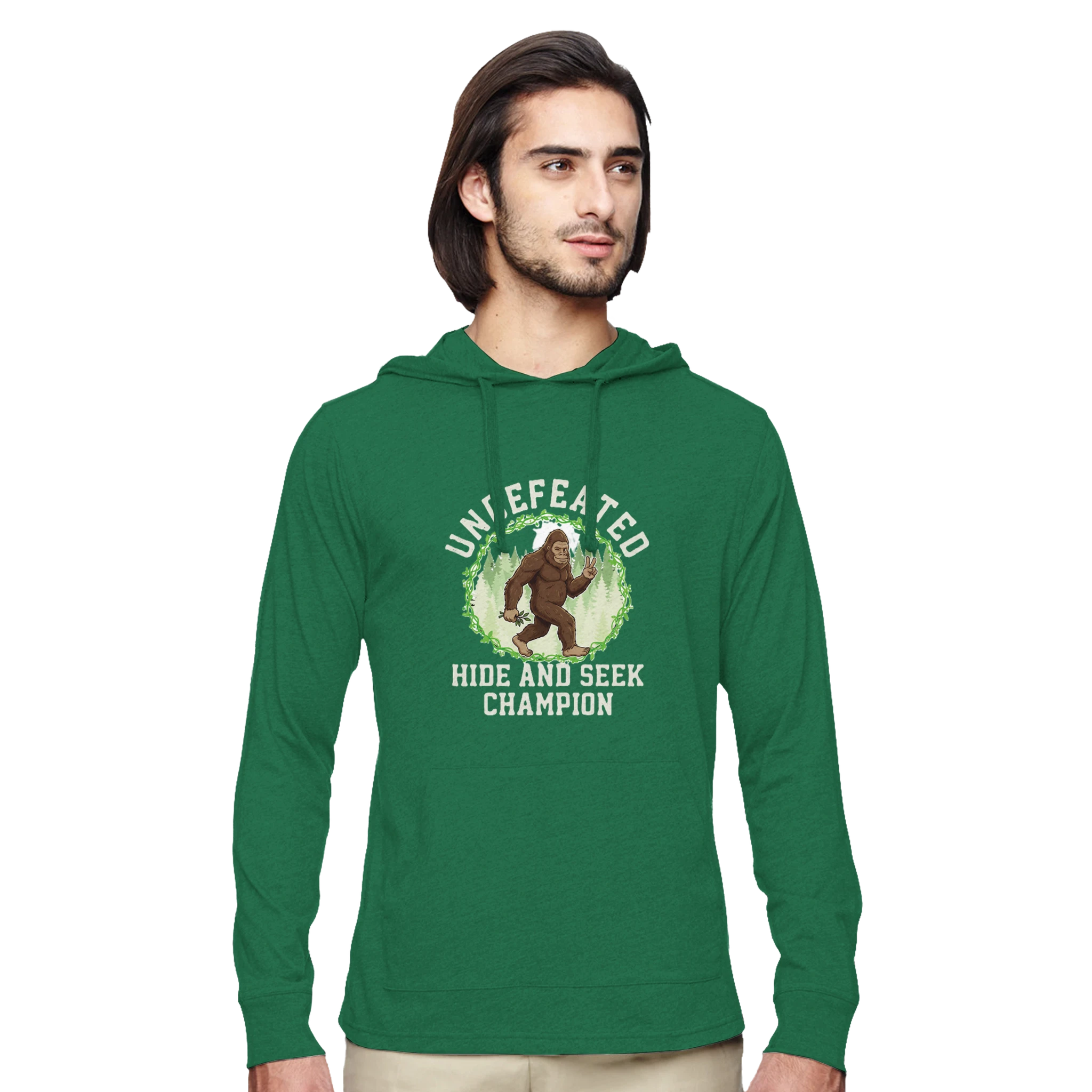 Man wearing a green bigfoot hoodie with a graphic design on a white background