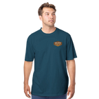Man wearing a teal t-shirt with a logo on a white background