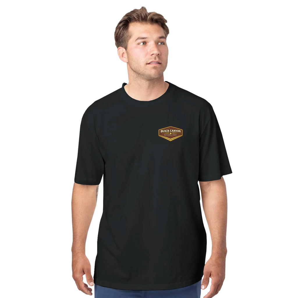 Man wearing a black t-shirt with a logo on a white background