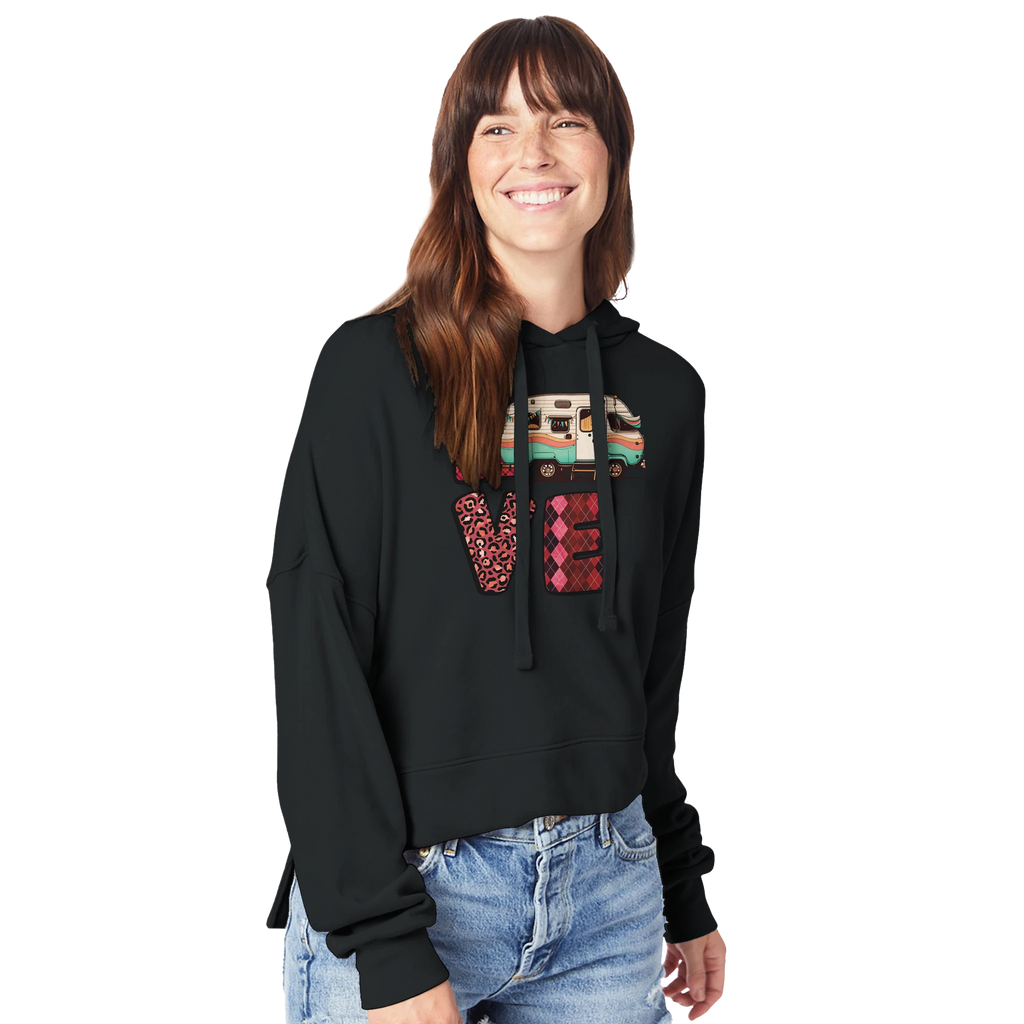 Woman wearing a black hoodie from the Love Collection with colorful patterns on a white background