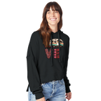 Woman wearing a black hoodie from the Love Collection with colorful patterns on a white background