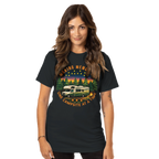 Woman wearing a black t-shirt with a graphic design of a camper van and nature scene.