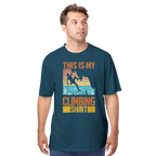 Man wearing a blue t-shirt with a climbing graphic and text on a white background