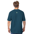 Man wearing a teal t-shirt with a logo on the back against a white background