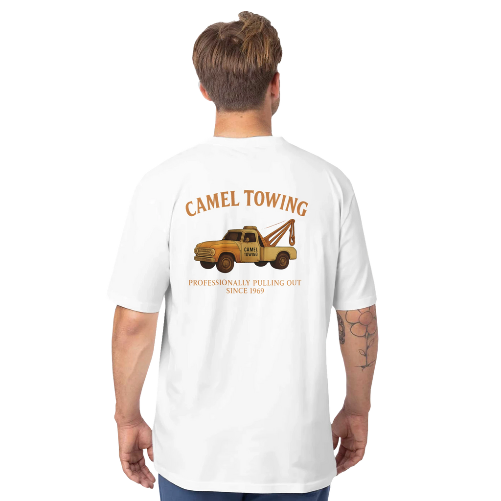 Person wearing a white t-shirt with a graphic of a tow truck and Camel Towing  on the back, on a white background.