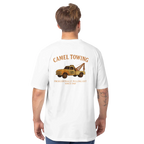 Person wearing a white t-shirt with a graphic of a tow truck and Camel Towing  on the back, on a white background.