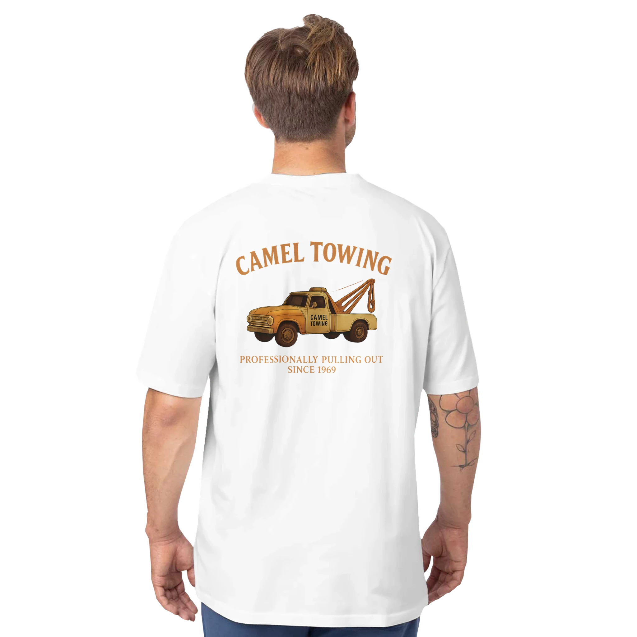 Person wearing a white t-shirt with a graphic of a tow truck and Camel Towing  on the back, on a white background.