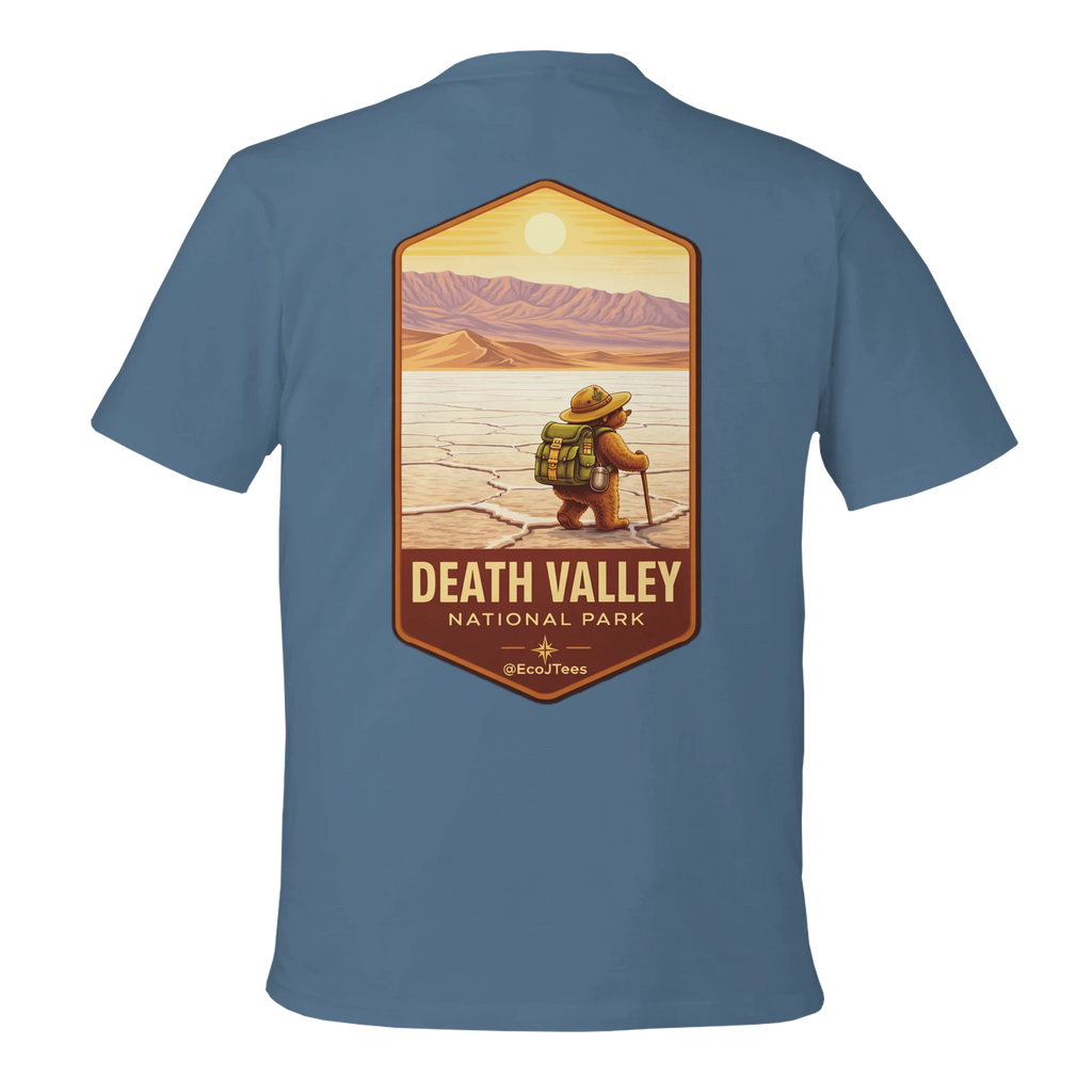 Blue t-shirt with a graphic of a person in a hat and backpack at Death Valley National Park on a white background