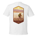 White t-shirt with a graphic of a person in a hat and backpack in Death Valley National Park on a white background