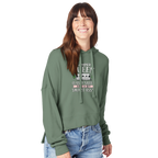 Woman wearing a green hoodie with Camper Queen text and graphics on a white background