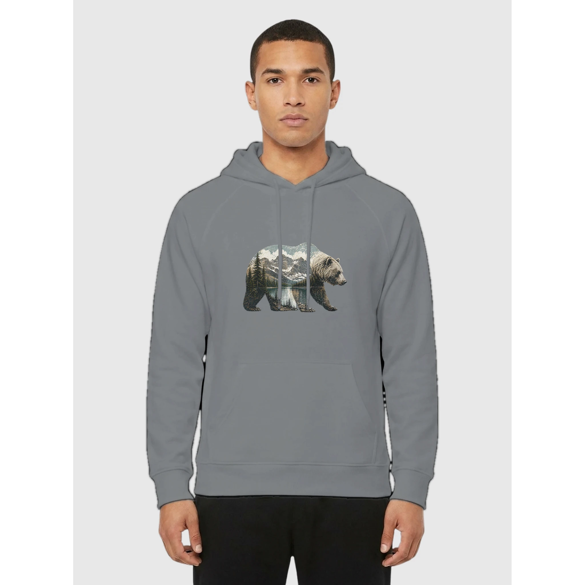 Person wearing a Bear silhouette filled with a Glacier-inspired alpine lake, mountain peaks, and evergreen forest landscape printed on a gray organic fleece pullover hoodie.