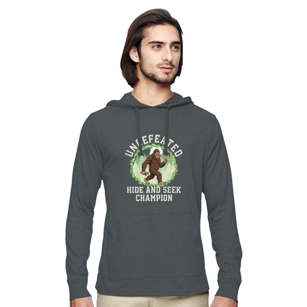 Man wearing a grey hoodie with a Bigfoot Graphic on a white background