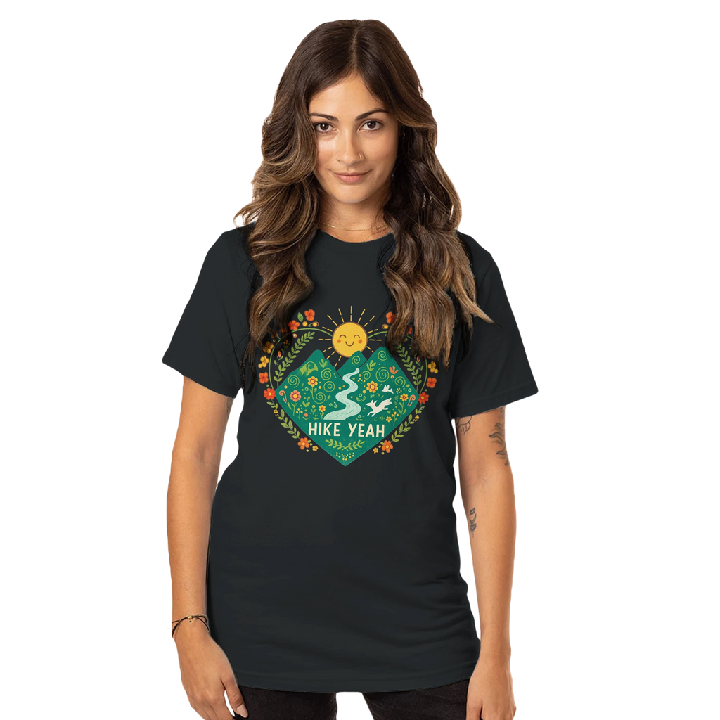 Woman wearing a Hike Yeah black t-shirt with a colorful graphic design on a white background