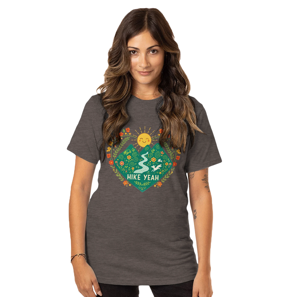 Woman wearing a dark gray t-shirt with a colorful graphic design on a white background