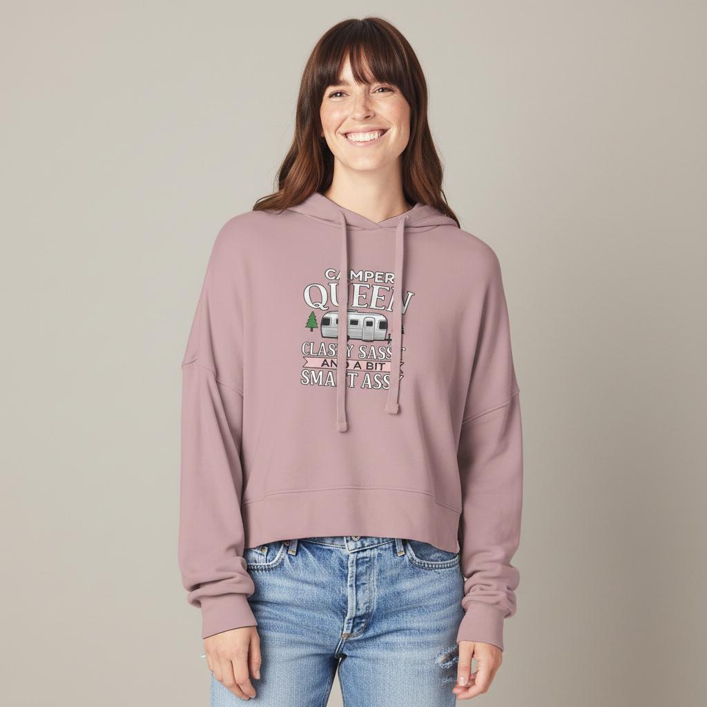 Person wearing a pink hoodie with Camper Queen text and graphics, standing against a plain background