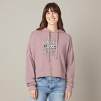 Person wearing a pink hoodie with Camper Queen text and graphics, standing against a plain background