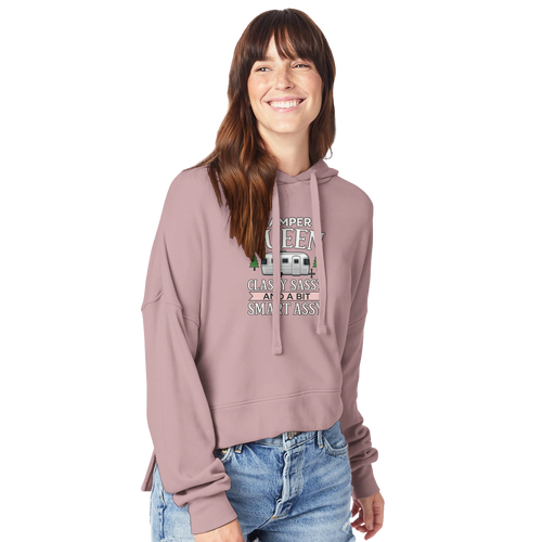 Woman wearing a pink Camper Queen hoodie with text and graphics on a white background