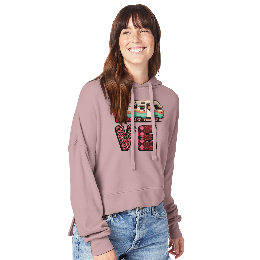 Woman wearing a pink hoodie with a colorful 'LOVE' graphic from the Love Collection on a white background