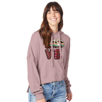 Woman wearing a pink hoodie with a colorful 'LOVE' graphic from the Love Collection on a white background