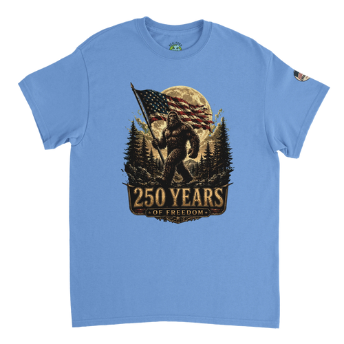 Blue t-shirt with a graphic of Bigfoot holding an American flag and '250 Years of Freedom' text on a white background.