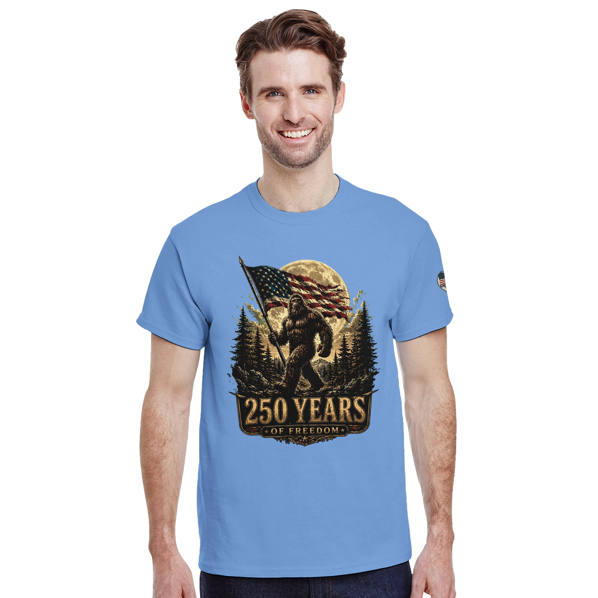 Man wearing a blue t-shirt with a Bigfoot graphic design on a white background