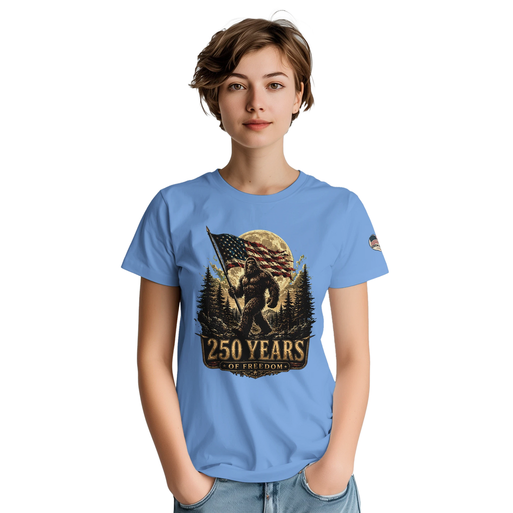 Woman wearing a blue t-shirt with a Bigfoot graphic design on a white background