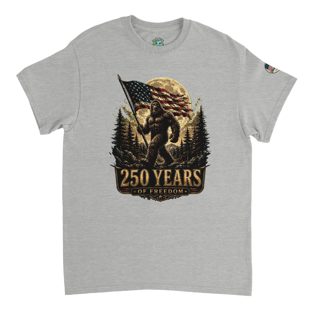 Gray t-shirt with a graphic of Bigfoot holding an American flag and '250 Years of Freedom' text on a white background.