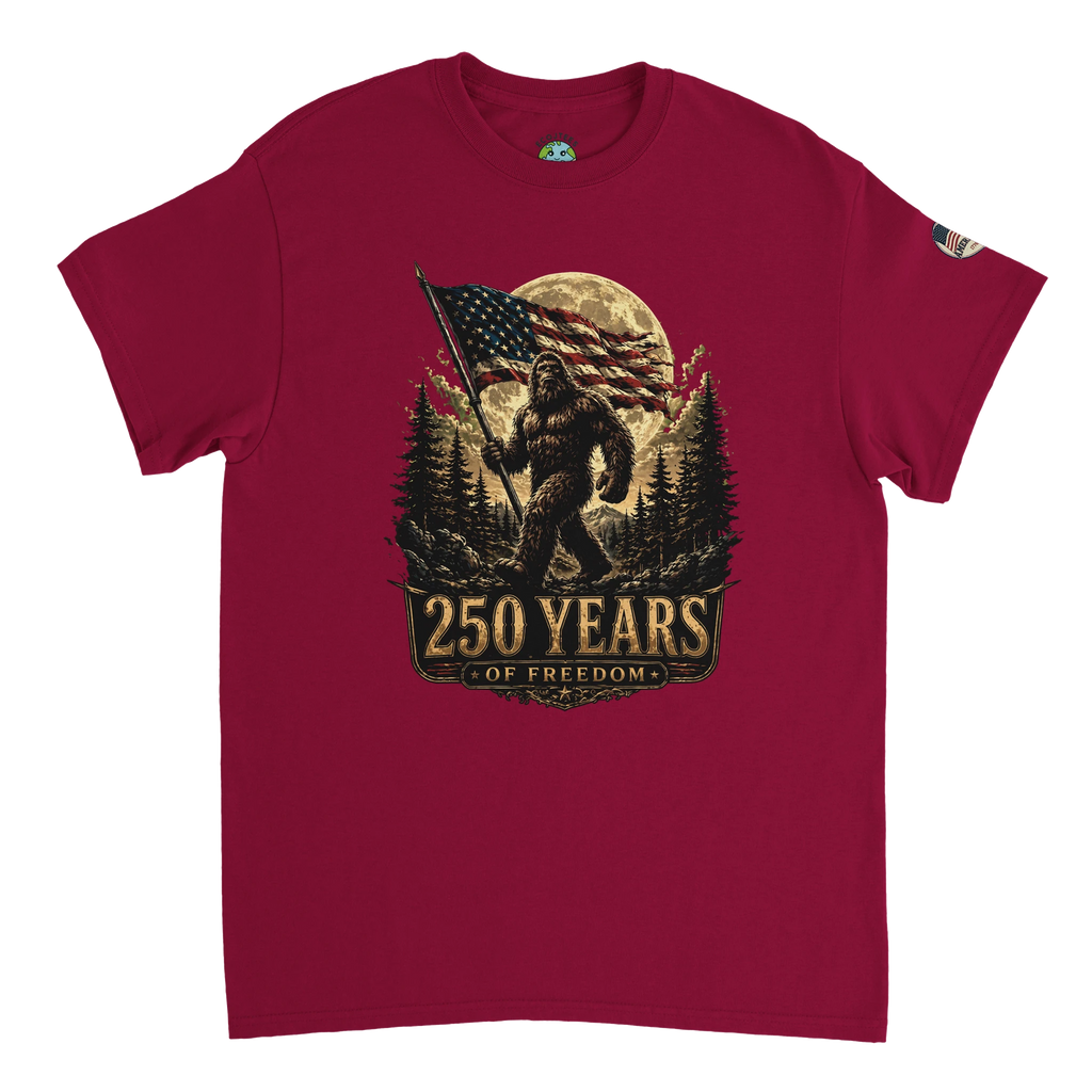 Red t-shirt with a graphic of Bigfoot holding an American flag and '250 Years of Freedom' text on a white background.