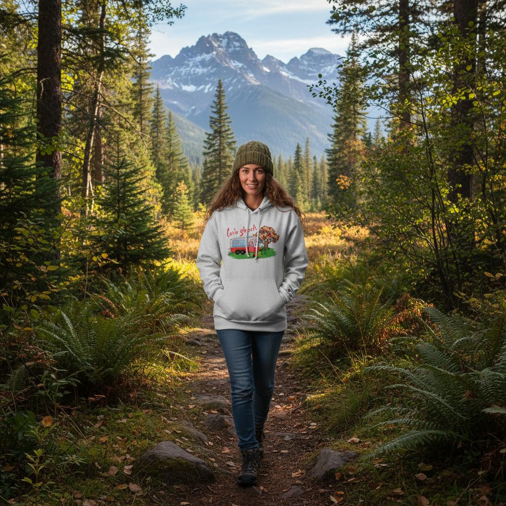 Woman walking on a trail in a forest with mountains in the background