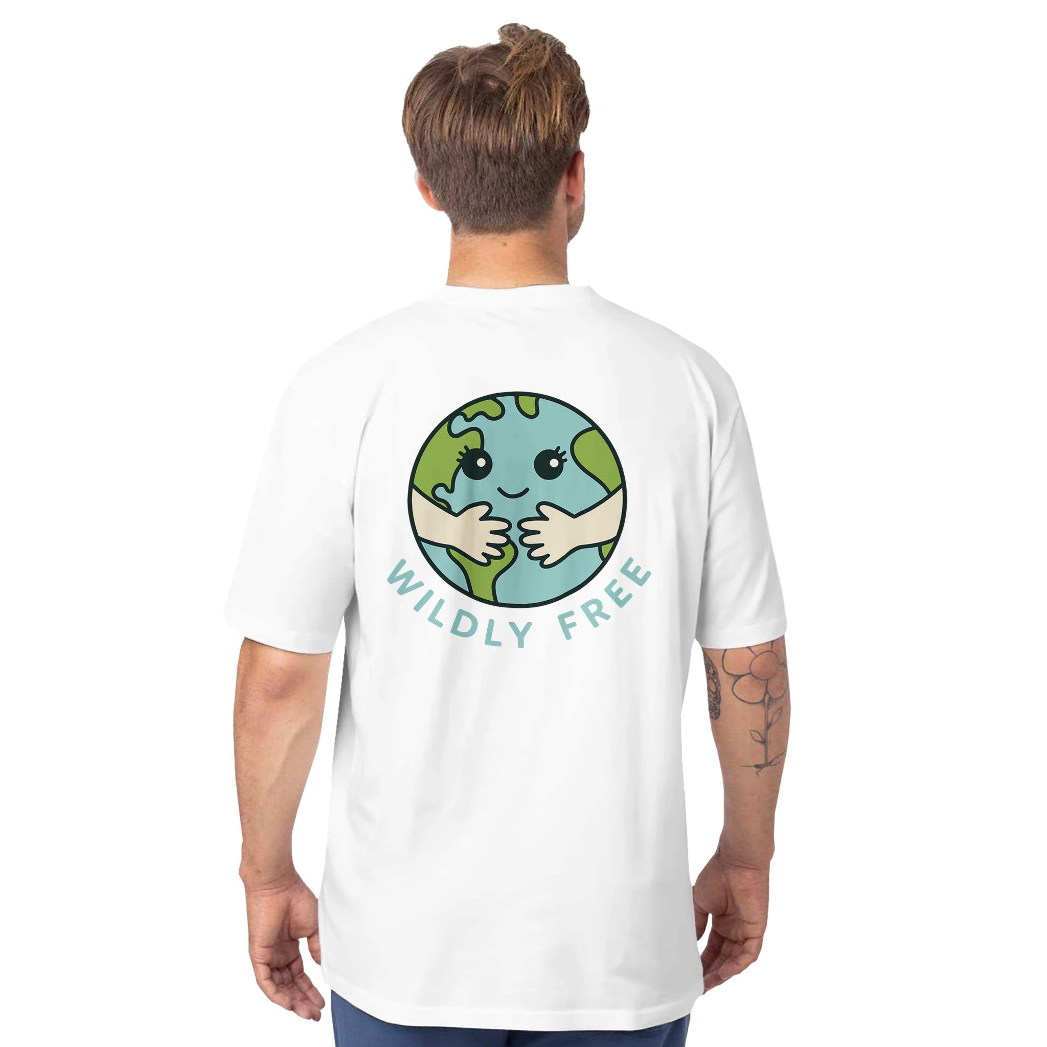 Person wearing a white t-shirt with a graphic of a smiling Earth and 'Wildly Free' text on the back.
